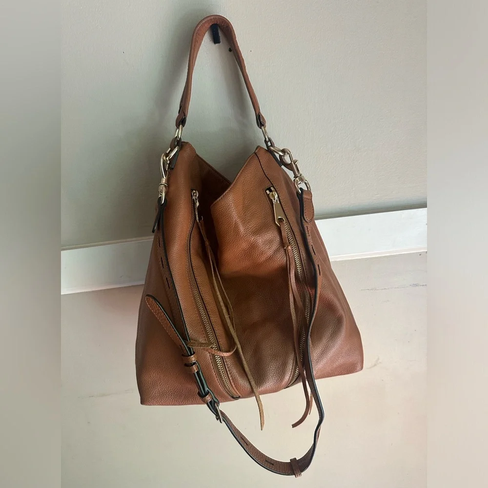 Rebecca Minkoff Moto hobo bag featuring prominent vertical zippers on the front.